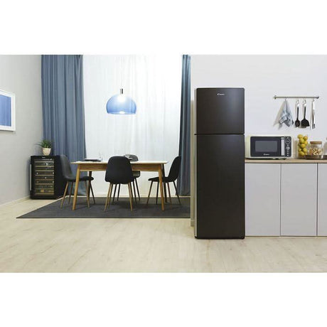 Retro microwave oven beige placed on white kitchen countertop next to black refrigerator in modern dining room