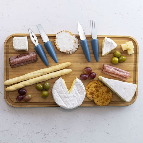 Calitek cheese knife set with stand featuring four blue-handled cheese knives on a wooden board with assorted cheeses and snacks