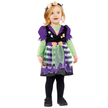 Toddler girl wearing a child miss frankie costume with purple and green dress and black leggings