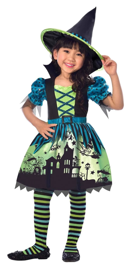 Child wearing a colorful child witch Halloween costume with hat and striped leggings