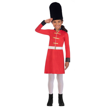 Child wearing childrens royal guard costume with red tunic and black bearskin hat saluting