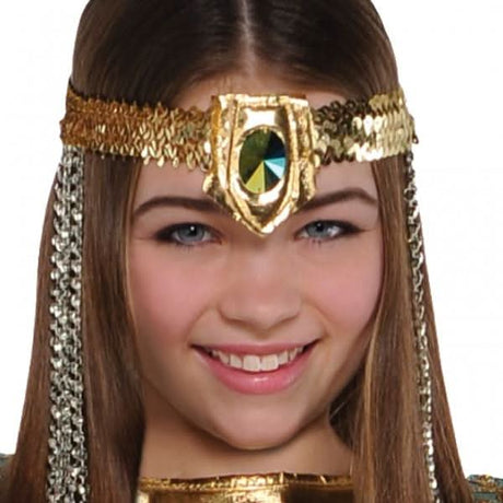 Girl wearing Cleopatra costume for kids with golden headpiece featuring a green gem and sequins
