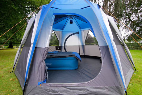 CLICKK Home Store 8 person family camping tent with spacious interior and blue gray design set up on green grass