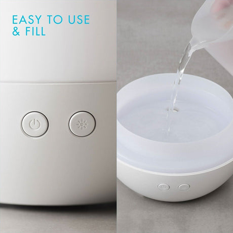 Homedics color changing essential oil diffuser being filled with water for easy use and relaxing aromas
