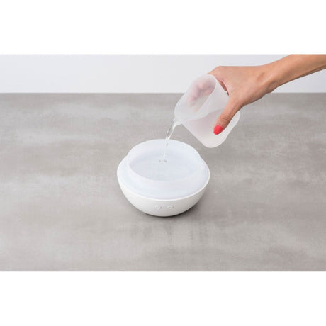 Homedics color changing essential oil diffuser with water being added for aromatherapy