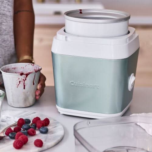 Cuisinart ice cream maker with stainless steel bowl and fresh berries on countertop