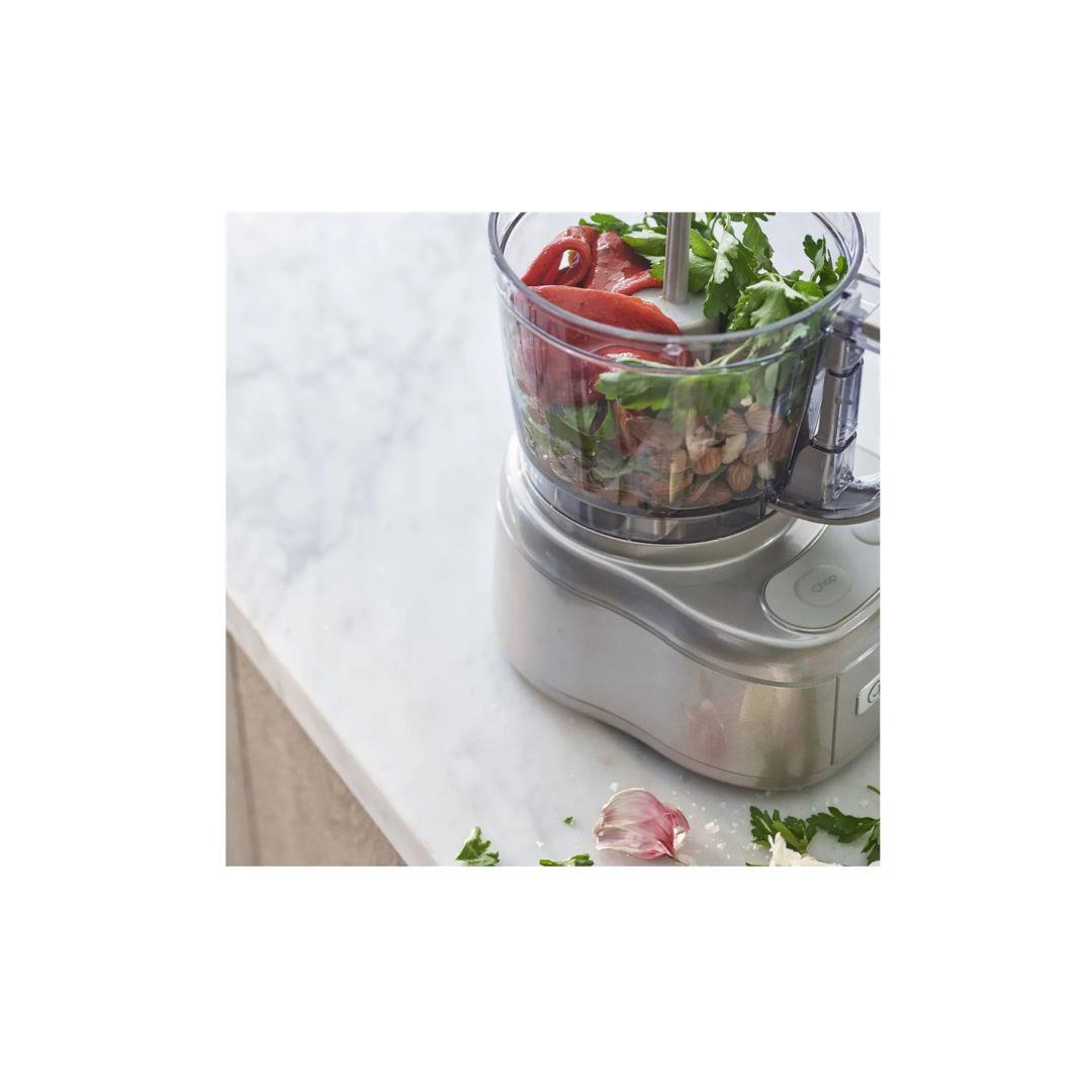 Cuisinart Mini Prep Pro food processor with fresh vegetables inside on marble countertop