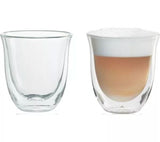 De'Longhi cappuccino glasses set with one empty and one filled with cappuccino and layered foam