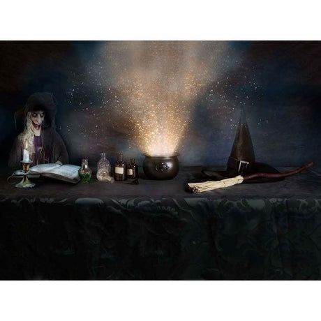 Deluxe witch hat with buckle next to a broomstick, potion bottles, and cauldron emitting magical light