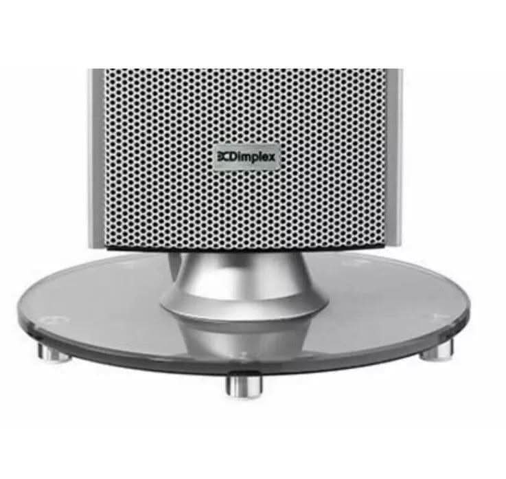 Close-up of silver Dimplex Studio G Tower Heater base with circular glass stand and ventilation grille