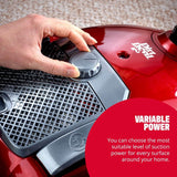 Hand adjusting suction power dial on red Dirt Devil vacuum cleaner for variable power settings