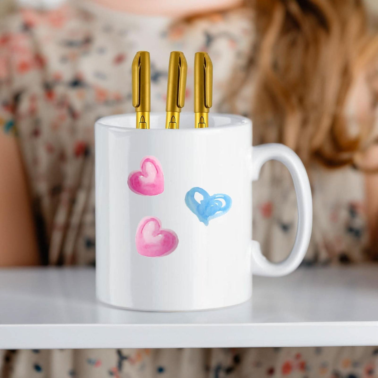 White ceramic mug with pink and blue hearts design from DIY ceramic mug coloring kit by CLICKK Home Store