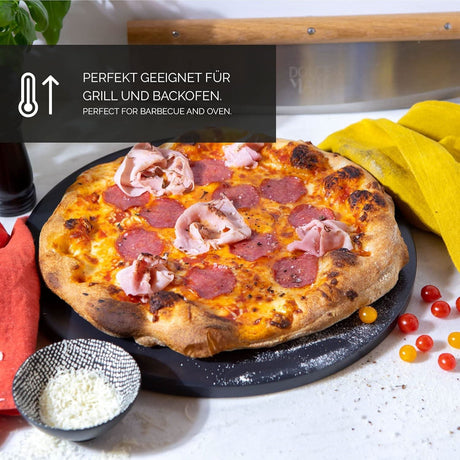 Black pizza stone for oven with freshly baked pepperoni and ham pizza on top, shown on kitchen counter