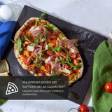Rectangular pizza stone for oven with freshly baked pizza topped with arugula and cherry tomatoes
