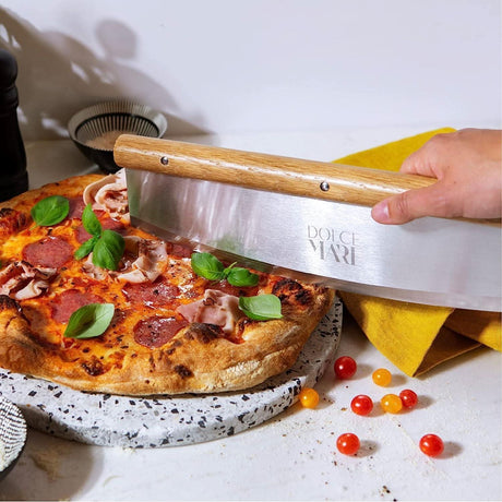 Dolce Mare stainless steel pizza cutter slicing a delicious pepperoni pizza with fresh basil