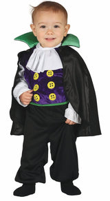 Toddler wearing toddler vampire costume with purple vest, green collar, black cape, and pants