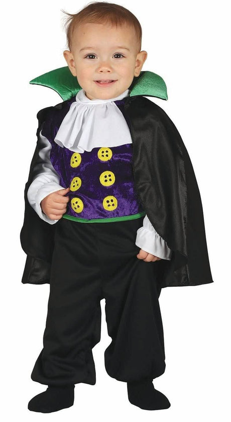 Toddler wearing toddler vampire costume with purple vest, green collar, black cape, and pants