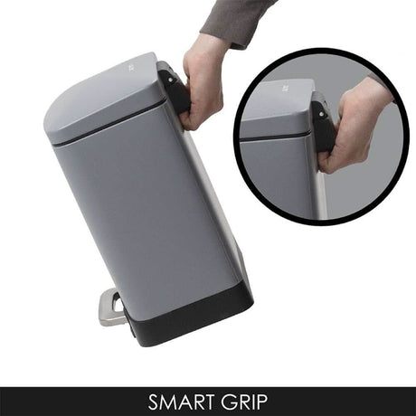 Calitek gray 12 litre pedal waste bin with smart grip handle being held for easy lifting