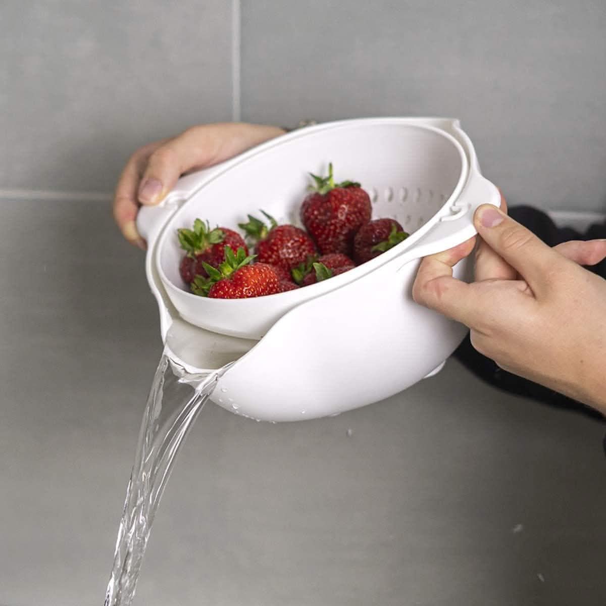Calitek detachable colander and bowl set draining water from fresh strawberries in white kitchen sink