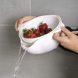 Calitek detachable colander and bowl set draining water from fresh strawberries in white kitchen sink