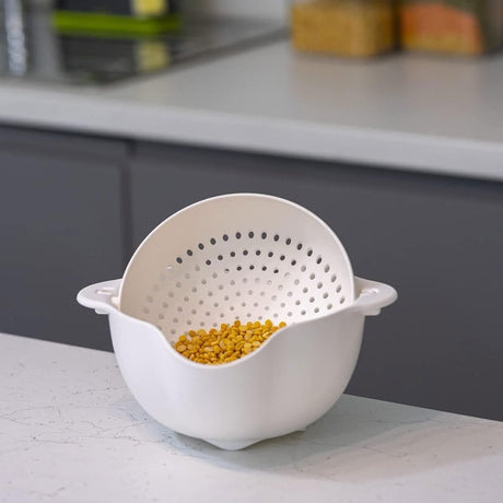 Calitek detachable colander and bowl set in white with yellow lentils inside on kitchen counter