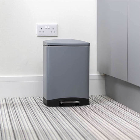 Calitek 6L pedal bin with soft close lid in gray with black base on striped carpet