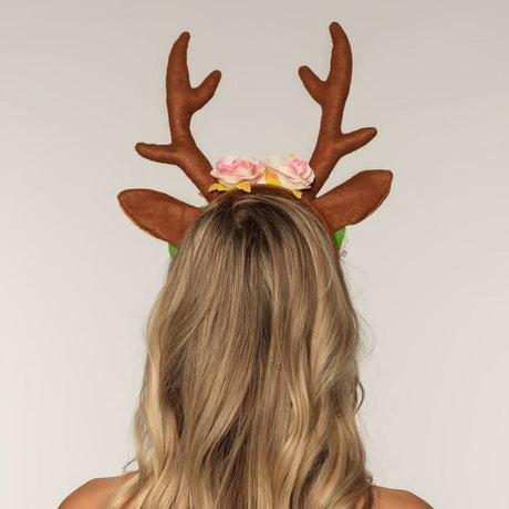 Reindeer antler headband with brown antlers and floral decoration worn on blonde hair