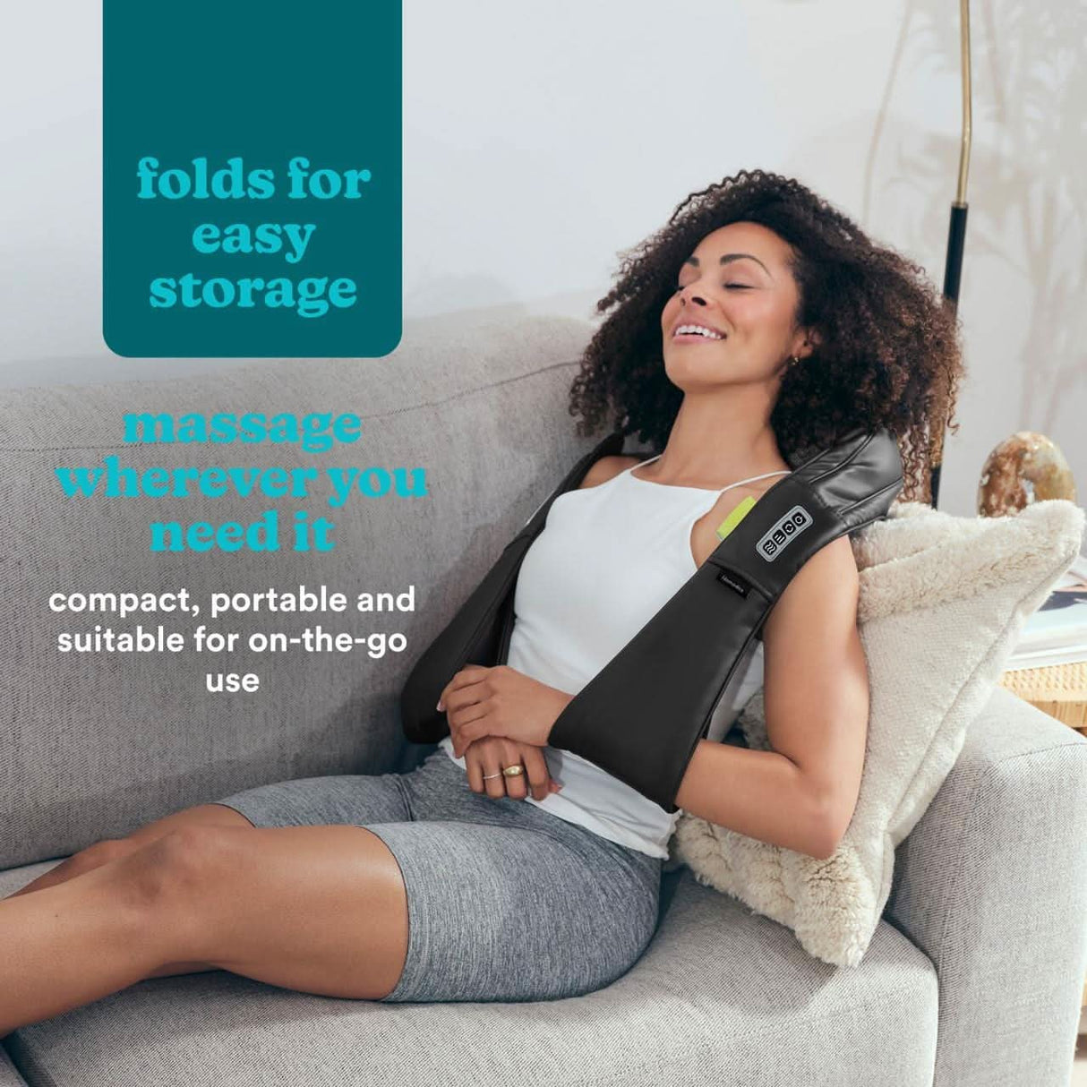 Woman relaxing on couch using Homedics neck massager with digital controls and ergonomic design