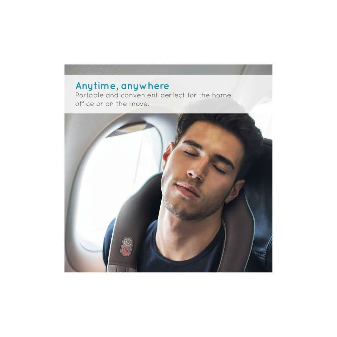 Man wearing Homedics neck massager with heat relaxing on airplane seat with eyes closed