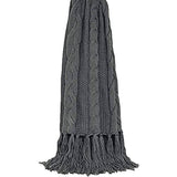 Light grey throw blanket with cable knit pattern and long fringe tassels hanging vertically