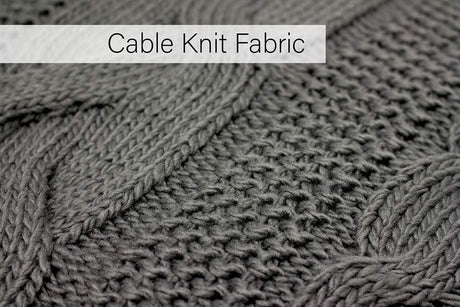 Close-up of cable knit fabric texture on a light grey throw blanket from CLICKK Home Store