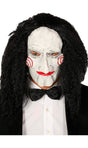 Men wearing a men's jigsaw puppet mask with white face, red spiral cheeks, and curly black hair