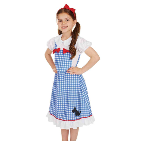 Girl wearing a blue gingham Dorothy costume for kids with a white blouse and red bow headband