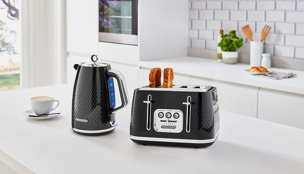 Morphy Richards black textured kettle with blue indicator and matching black toaster on white kitchen countertop