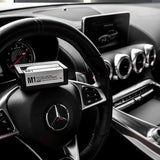 Patricks M1 light hold gel box placed on the steering wheel inside a luxury car interior