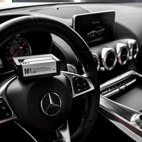 Patricks M1 light hold gel box placed on the steering wheel inside a luxury car interior