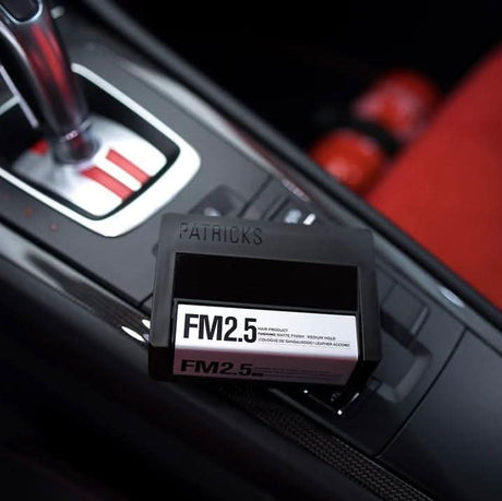 CLICKK Home Store FM2.5 medium hold hair gel product placed on car center console