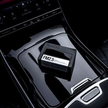 CLICKK Home Store medium hold hair gel container placed on glossy black car center console