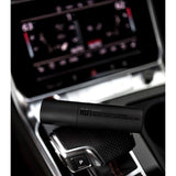 Patricks RD1 hair loss spray bottle placed on car gear shift console with black matte finish