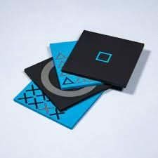 PlayStation coaster set featuring black and blue designs inspired by iconic controller symbols
