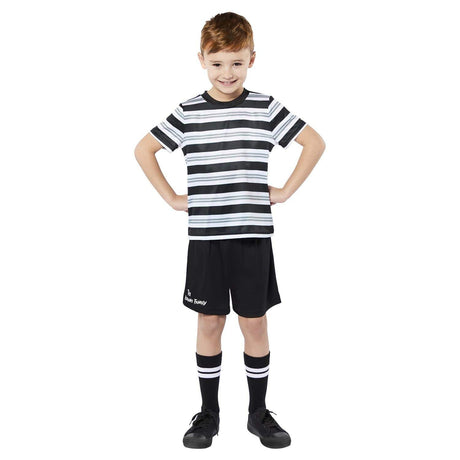 Boy wearing Pugsley Addams Family costume with striped shirt black shorts and matching socks