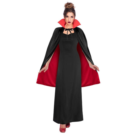 Woman wearing a reversible black red cape with high collar over a long black dress