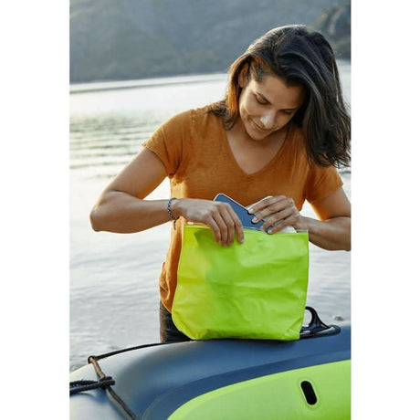 Woman preparing gear near an inflatable family boat by CLICKK Home Store on the water