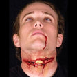 Man wearing slashed trachea prosthetic makeup with realistic blood and wound effects for horror costume