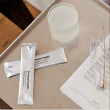 CLICCK Home Store immune supplement for men sachets on table with glass of water and reading glasses
