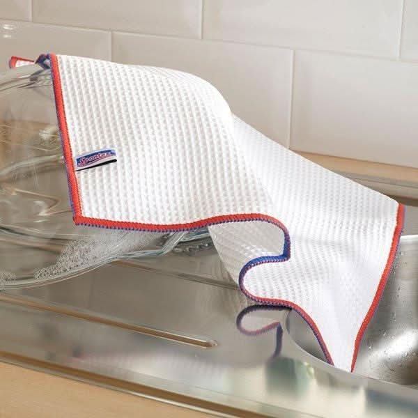 White waffle texture Spontex kitchen cloth with red and blue edging drying glassware on kitchen sink for Spontex kitchen cloths bulk buy
