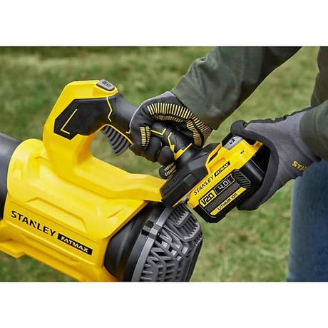 Person attaching battery to Stanley Fatmax 18V cordless blower in yellow and black design