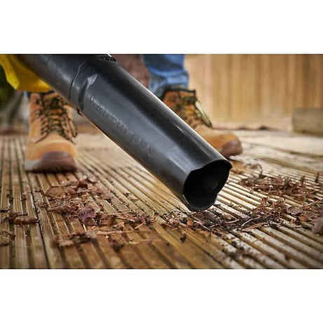 Stanley Fatmax 18V cordless blower clearing leaves and debris from wooden deck surface