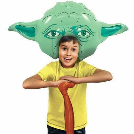 Child wearing Star Wars inflatable costume featuring large Yoda head and holding a brown cane