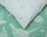 CLICKS Home Store superking reversible duvet cover with green bird and acorn pattern on one side and light blue polka dot pattern on the other
